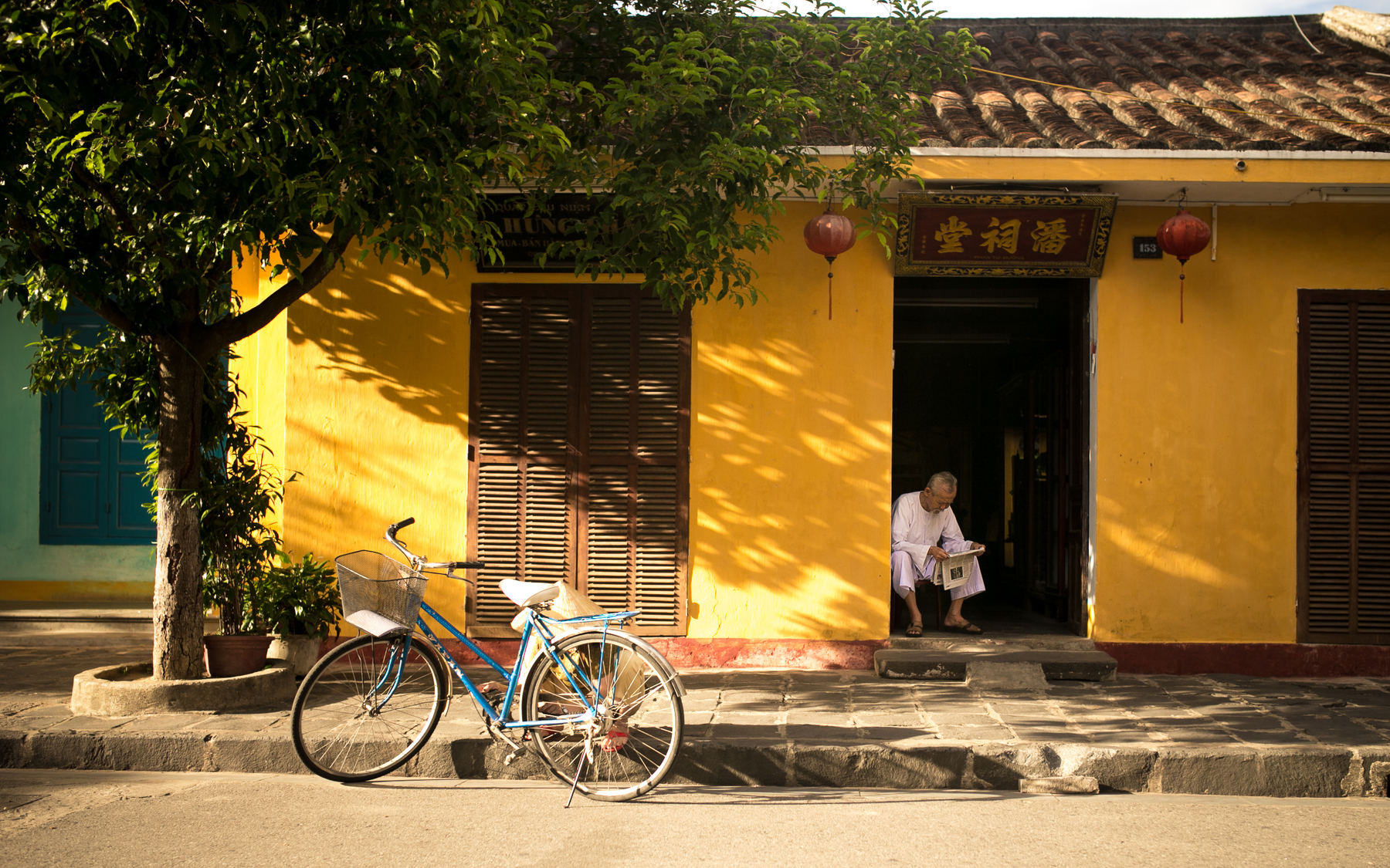 A bicycle outside a yellow house in China