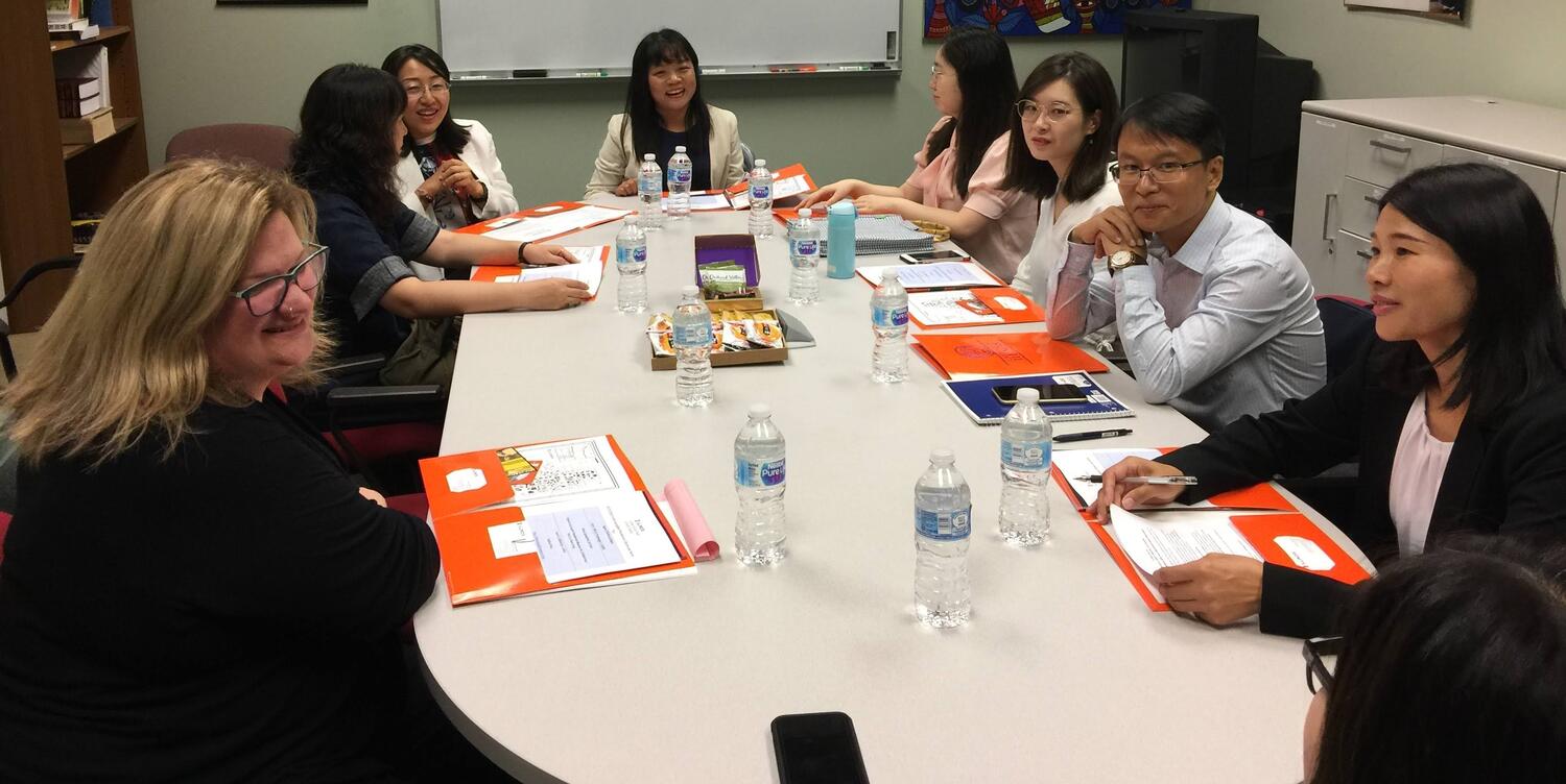 Visiting Asian Scholars and CEAPS Staff sitting together at a table